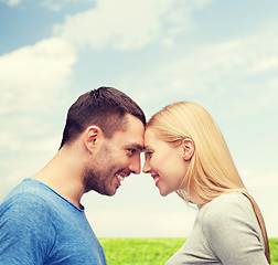 Image showing smiling couple looking at each other