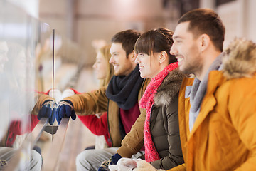 Image showing happy friends watching hockey game on skating rink