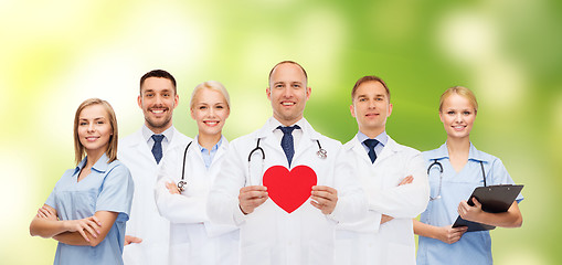 Image showing group of smiling doctors with red heart shape