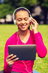 Image showing smiling woman with tablet pc outdoors