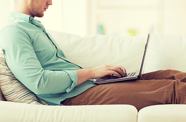 Image showing close up of man working with laptop at home