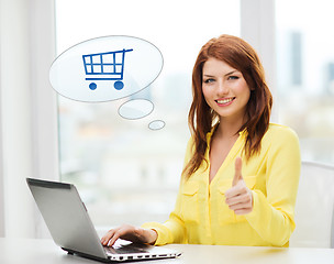 Image showing smiling woman with laptop computer shopping online