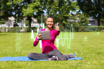 Image showing smiling woman with tablet pc showing thumbs up