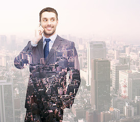 Image showing smiling young businessman over city background
