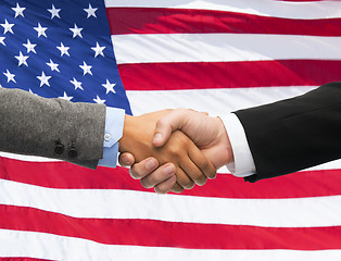 Image showing close up of handshake over american flag