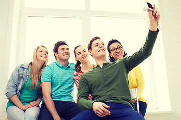 Image showing five smiling students taking picture with camera