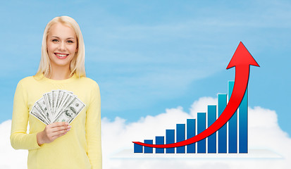 Image showing smiling woman with growth chart and dollar money