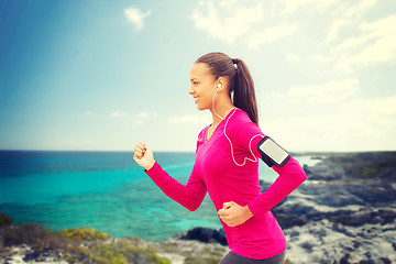 Image showing smiling young woman running outdoors