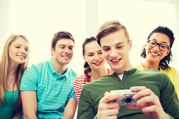 Image showing smiling students with digital camera at school