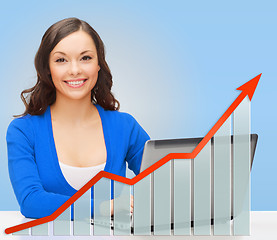 Image showing smiling woman with laptop and growth chart