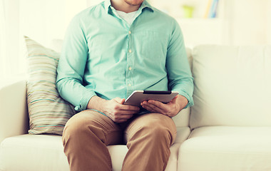 Image showing close up of man with tablet pc computer at home