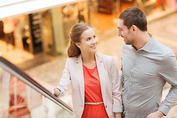 Image showing happy young couple with shopping bags in mall