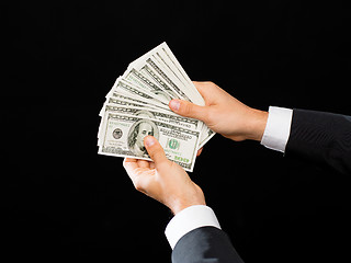 Image showing close up of male hands holding dollar cash money