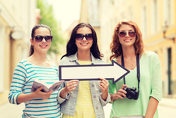 Image showing smiling teenage girls with white arrow outdoors