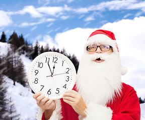 Image showing man in costume of santa claus with clock