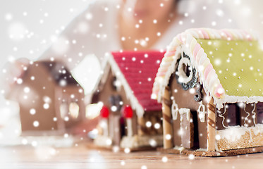 Image showing close up of woman making gingerbread houses