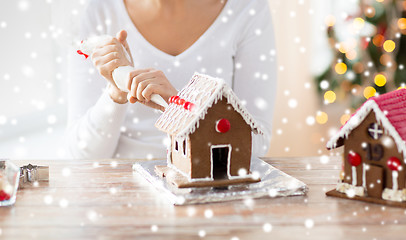 Image showing close up of woman making gingerbread houses