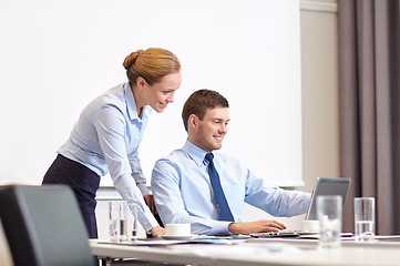 Image showing businessman and secretary with laptop in office