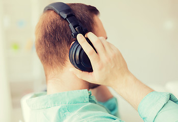 Image showing close up of man in headphones at home