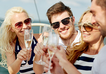 Image showing smiling friends with glasses of champagne on yacht