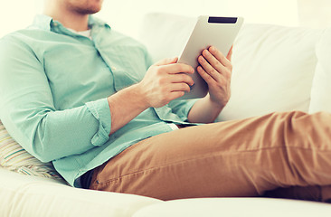 Image showing close up of man with tablet pc computer at home