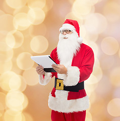 Image showing man in costume of santa claus with notepad