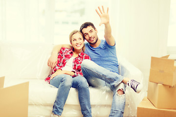 Image showing smiling couple relaxing on sofa in new home