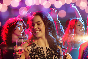 Image showing smiling friends with glasses of champagne in club