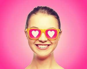 Image showing smiling teenage girl in pink sunglasses