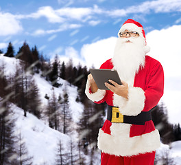 Image showing man in costume of santa claus with tablet pc