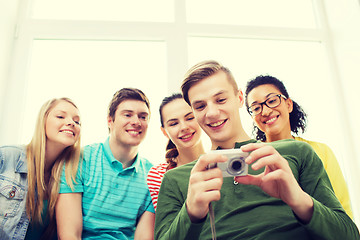 Image showing smiling students with digital camera at school