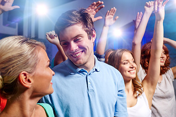 Image showing smiling friends at concert in club