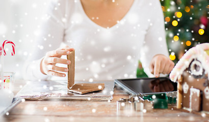 Image showing close up of woman making gingerbread houses