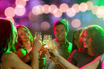 Image showing smiling friends with glasses of champagne in club