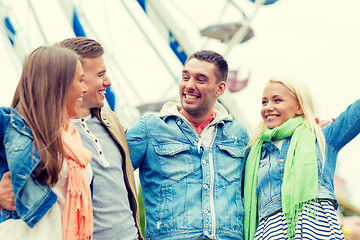 Image showing group of smiling friends in amusement park