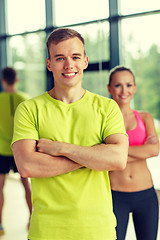 Image showing smiling man and woman in gym