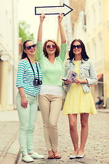 Image showing smiling teenage girls with white arrow outdoors