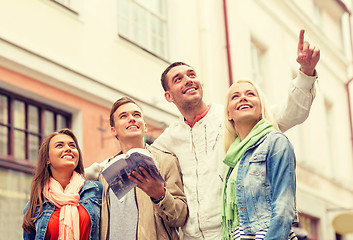 Image showing group of friends with city guide exploring town