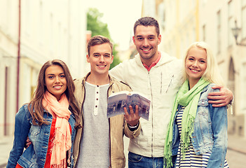 Image showing group of friends with city guide exploring town