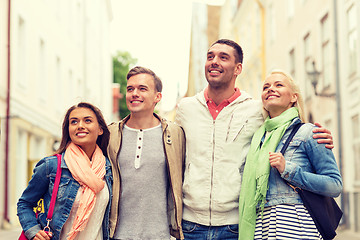 Image showing group of smiling friends walking in the city