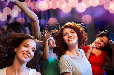 Image showing smiling friends dancing in club