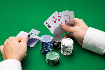 Image showing poker player with cards and chips at casino