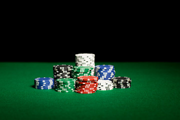 Image showing close up of casino chips on green table surface