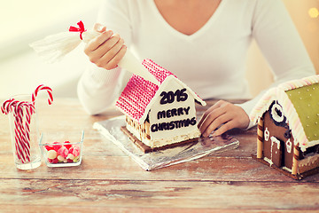 Image showing close up of woman making gingerbread houses