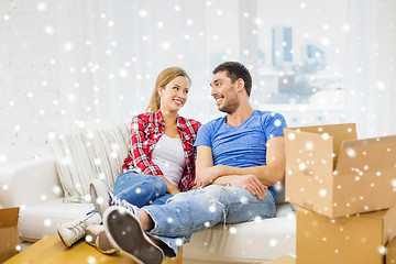 Image showing smiling couple relaxing on sofa in new home