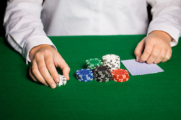 Image showing holdem dealer with playing cards and casino chips