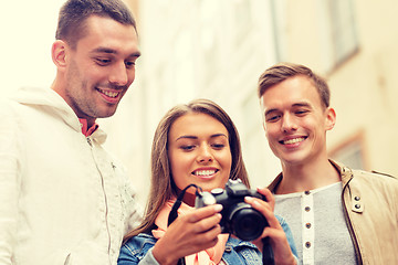 Image showing group of smiling friends with digital photocamera