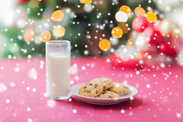 Image showing close up of cookies and milk glass on table