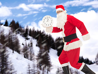 Image showing man in costume of santa claus with clock