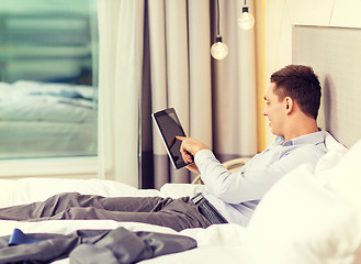 Image showing happy businesswoman with tablet pc in hotel room